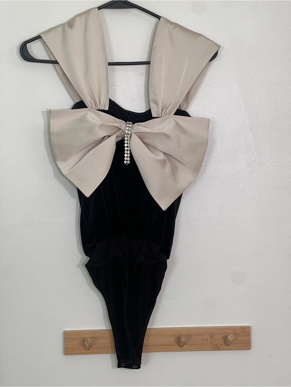 Express NWT women’s small Black Velvet bodysuit w/ Cream Bow & Crystal Drop